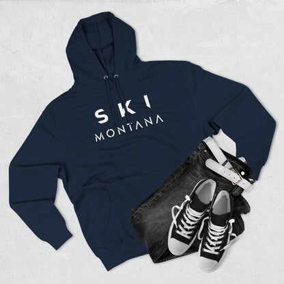 Navy hoodie with 'Ski Montana' text, black jeans, and black sneakers on a light gray background