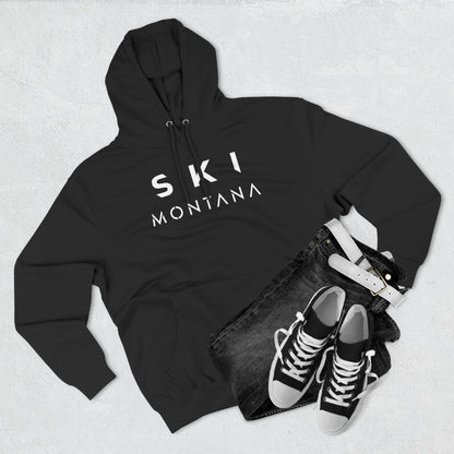 Black hoodie with 'Ski Montana' text, black jeans, and black sneakers on a light gray background