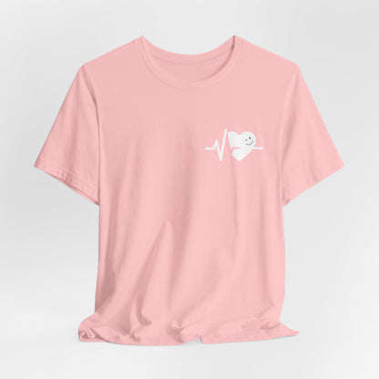 Pink t-shirt with a white heart smile face graphic on a light gray background